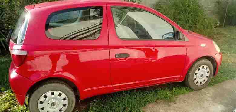 Desni bočni prikaz crvenog automobila Toyota Yaris
